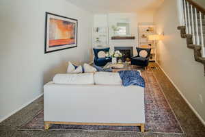 Living room with built in features and carpet floors