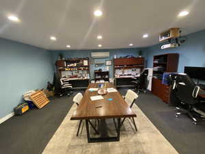 Dining area featuring concrete flooring and a wall mounted air conditioner