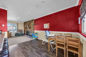 Dining room featuring wood-type flooring and ornamental molding