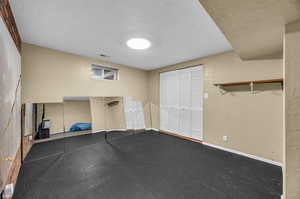 Interior space featuring a textured ceiling, Walk-in Closet