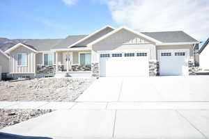 Craftsman-style home featuring a garage and a mountain view