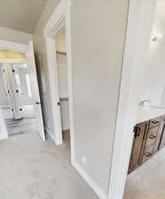 Corridor with light colored carpet