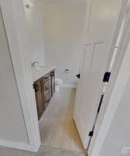 Bathroom with vanity, tile patterned floors, and toilet