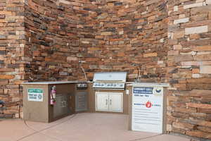 View of patio featuring a grill