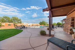 View of patio with a fenced in pool