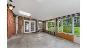 Huge unfinished Den  with skylights, french and sliding glass door.