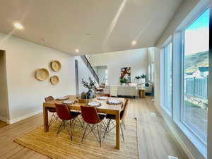 Dining space with light hardwood / wood-style flooring