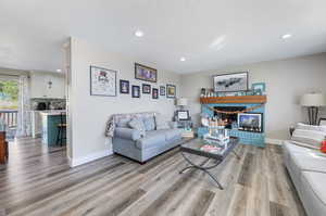 Living room featuring a textured ceiling and light hardwood / wood-style flooring