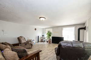 Living room with tile flooring and a textured ceiling