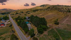 Aerial view at dusk featuring a rural view and a mountain view