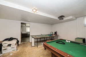 Game room featuring a textured ceiling and pool table