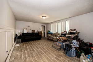 Living room featuring tile flooring and a textured ceiling