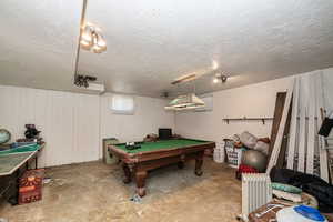 Recreation room featuring a textured ceiling, and pool table