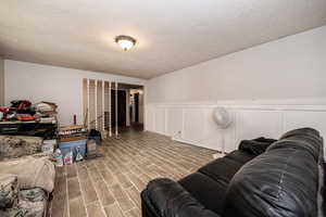 Living room with tile flooring and a textured ceiling