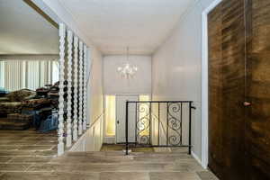 Interior space with a textured ceiling and chandelier