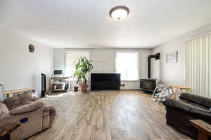 Living room featuring tile flooring and a propane stove