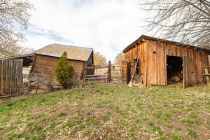 Fence, an outbuilding, and a pole building