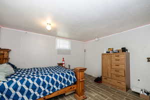 Bedroom with tile flooring and a textured ceiling