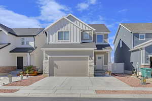 View of front of property with a garage and large driveway