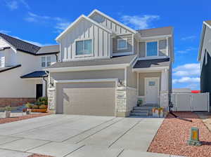 View of front of property featuring a garage and entry