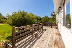 Wooden deck featuring a lawn