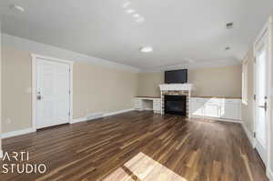 Unfurnished living room with wood-type flooring and a fireplace