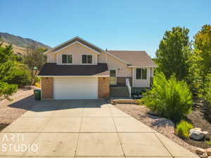 View of front of property featuring a garage and a mountain view