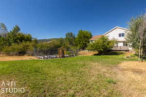 View of yard with a wooden deck