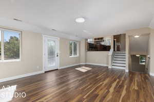 Unfurnished living room featuring dark hardwood / wood-style floors