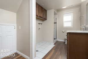 Bathroom featuring vanity, hardwood / wood-style floors, walk in shower, and toilet