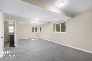 Carpeted spare room featuring a textured ceiling