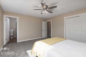 Bedroom featuring ceiling fan, ensuite bathroom, a closet, and carpet floors