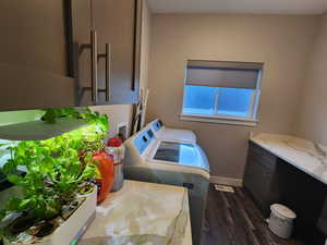 Bathroom featuring hardwood / wood-style flooring, washing machine and dryer, and vanity