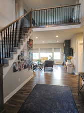 Interior space featuring hardwood / wood-style flooring and a towering ceiling