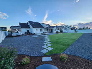 Yard at dusk featuring a patio area