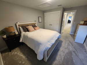 Bedroom with carpet and a closet