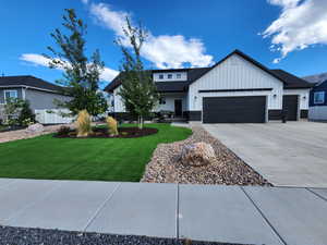 View of front facade with a front yard and a garage