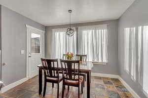 Dining space with dark tile patterned flooring