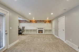 Unfurnished living room with light colored carpet