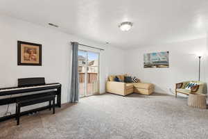 Sitting room featuring light carpet