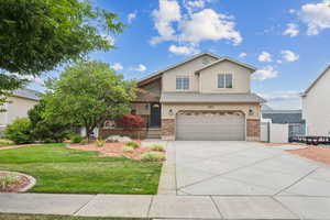 View of property with a garage and a front yard