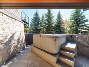 View of patio with a hot tub