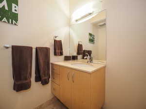 Bathroom featuring tile patterned flooring and vanity