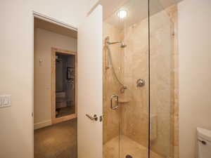 Bathroom featuring an enclosed shower and toilet