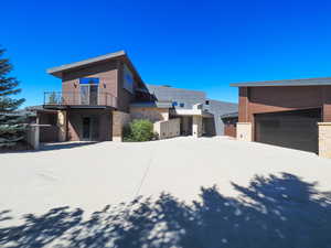 View of property exterior with a balcony and a garage