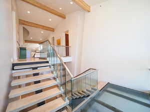 Stairway with beam ceiling and a high ceiling