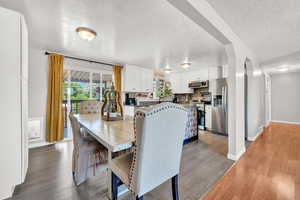 Dining room with a textured ceiling and LVP