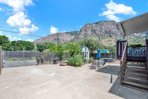 View of patio / terrace with a mountain view and a shed, ample parking