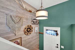 Foyer entrance featuring wood accent wall