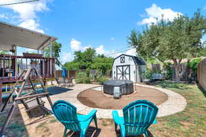 View of patio with wing, hot tub and a shed